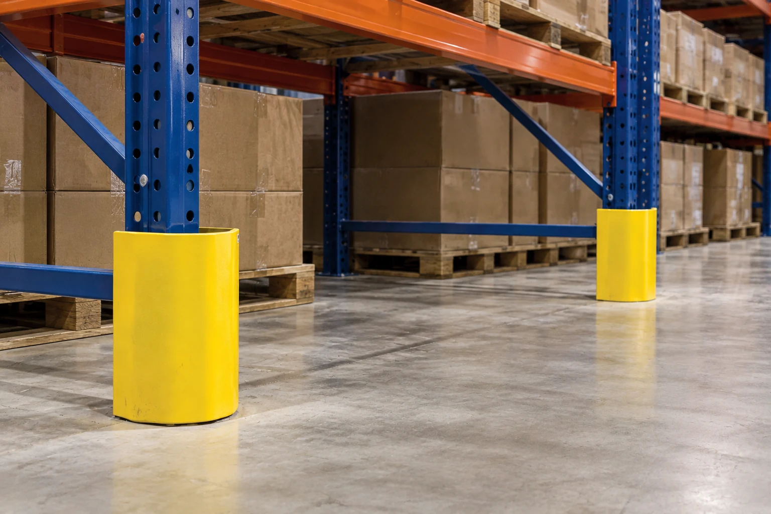 Rack column protectors and the surrounding floor footprint along an aisle.