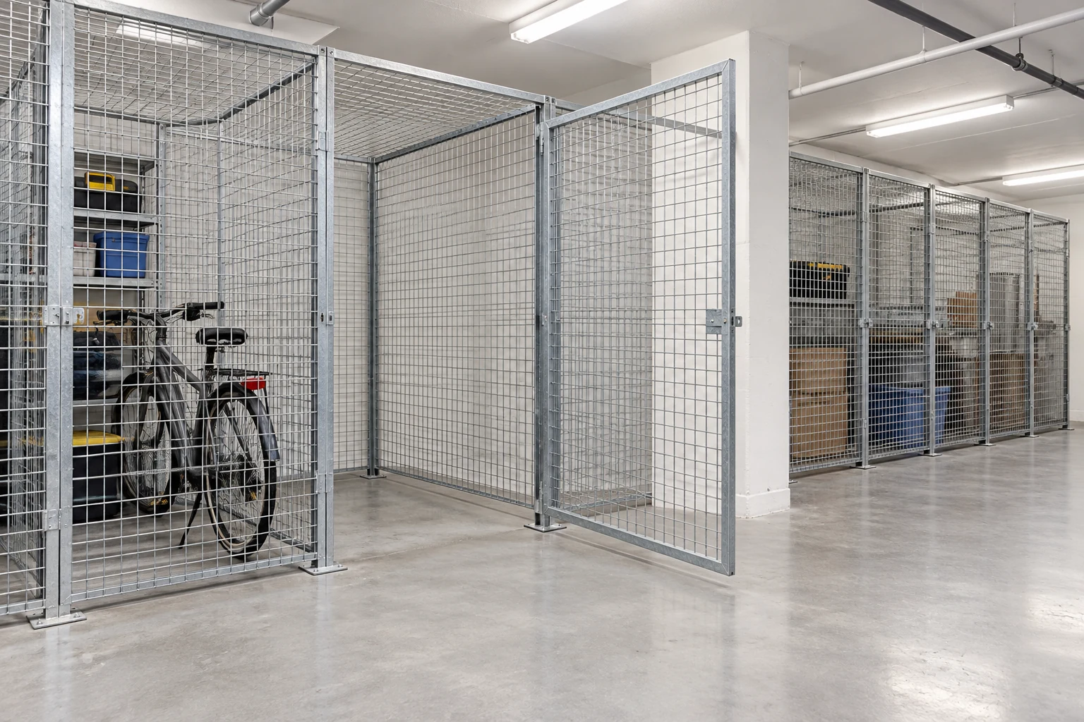 Open locker door and clear approach beside an occupied bicycle compartment.